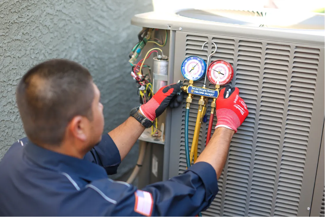 HVAC technician checking refrigerant levels during spring HVAC maintenance in Arizona