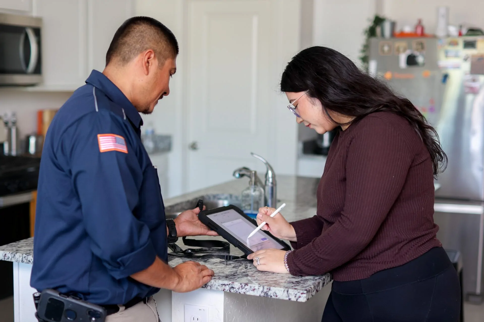 Canilu Air plumber reviewing upfront estimate with a Phoenix homeowner after summer plumbing repairs in AZ