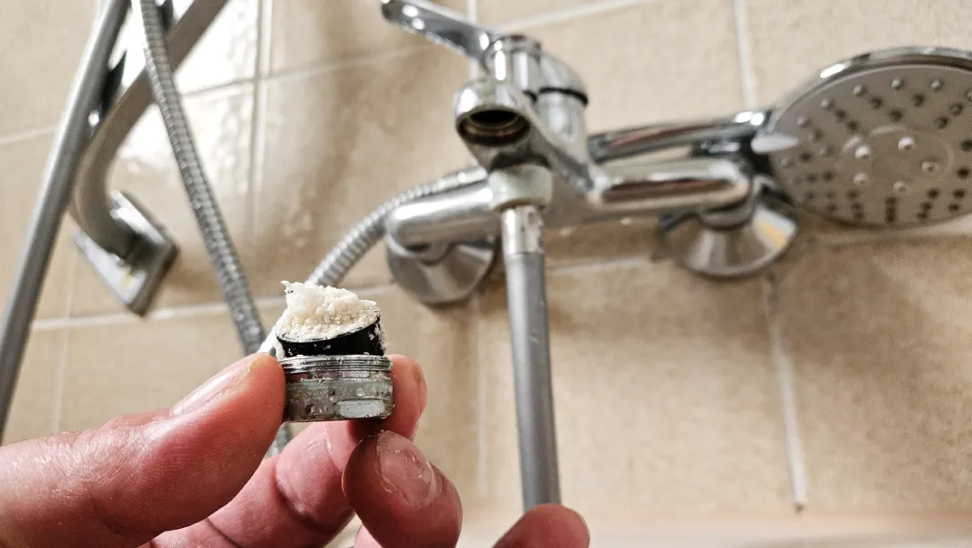 Mineral buildup on faucet aerator showing hard water and Phoenix plumbing issues