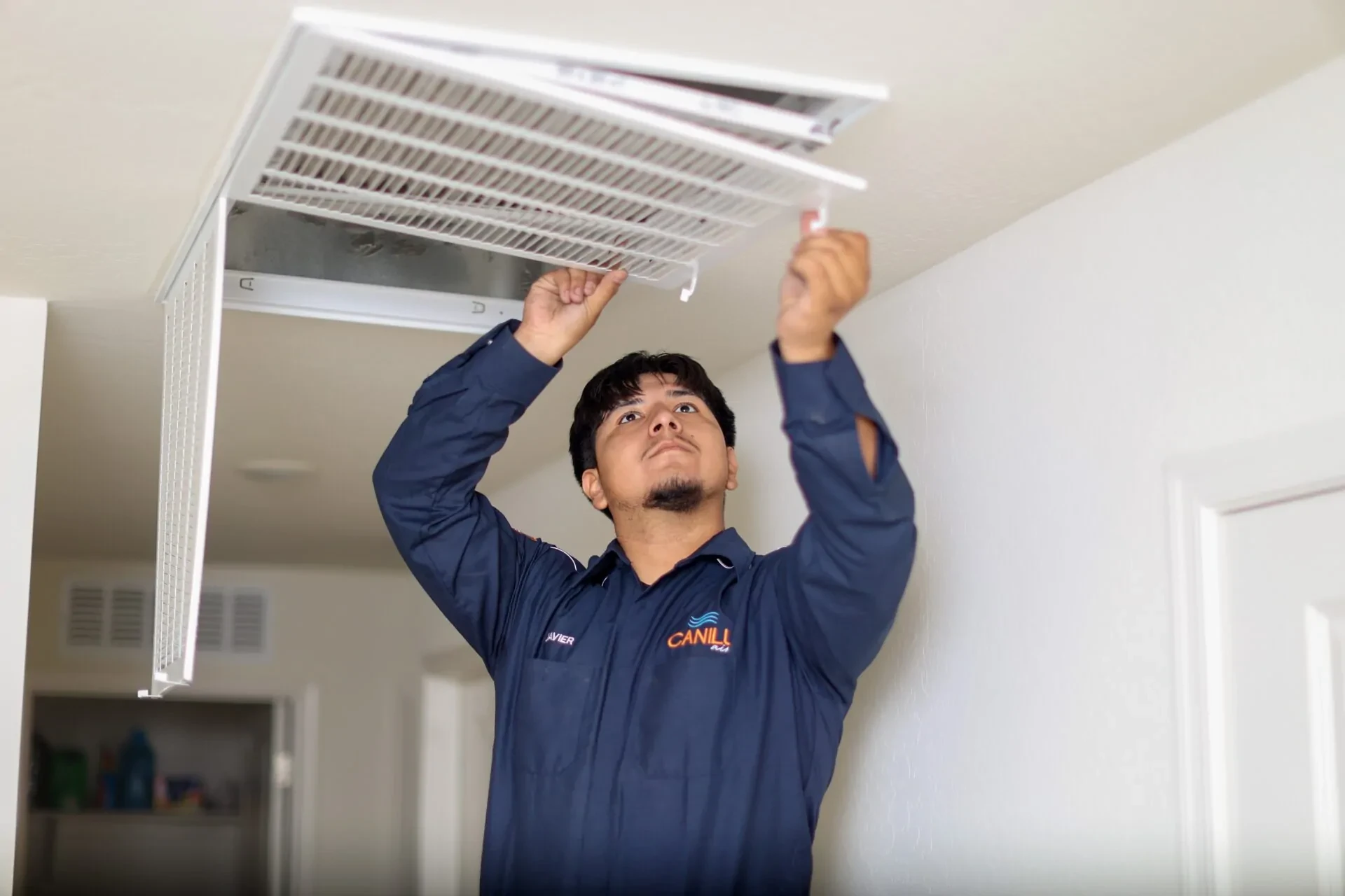 Canilu Air technician performing Duct Cleaning Phoenix service on a ceiling vent